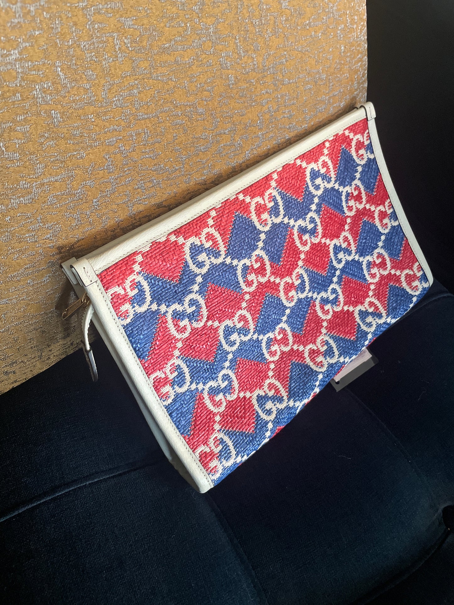 Beautiful Montecarlo pouch/clutch featuring a bold red, blue, and white GG geometric monogram pattern with cream trim and a brown leather Montecarlo logo patch.